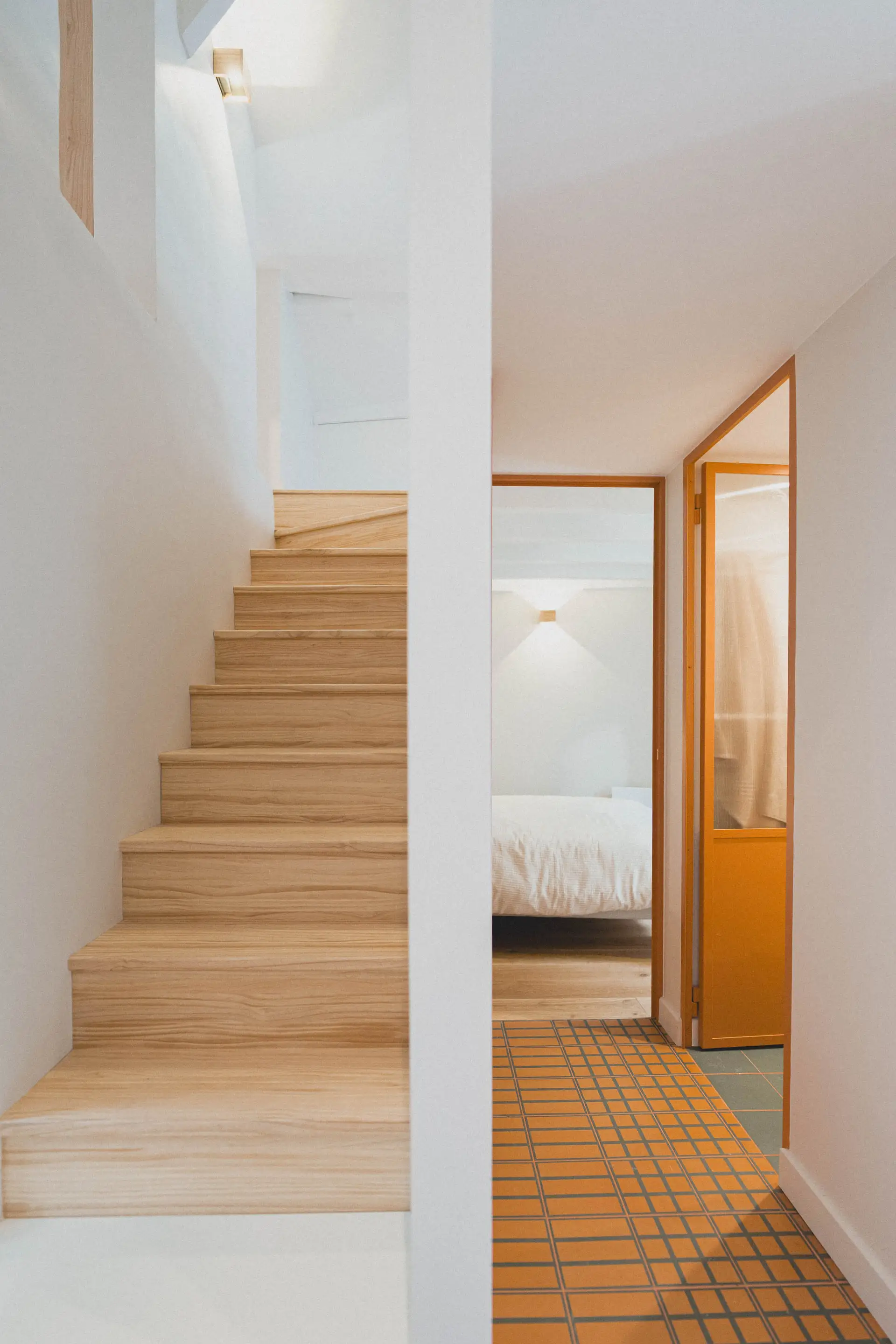Escalier en bois clair menant à la mezzanine