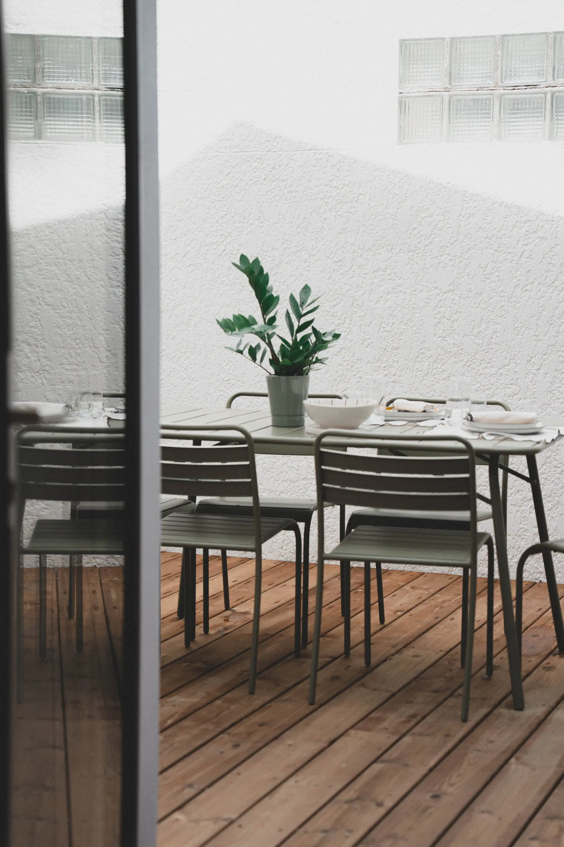 La terrasse dressée pour le déjeuner, vue depuis la porte-fenêtre